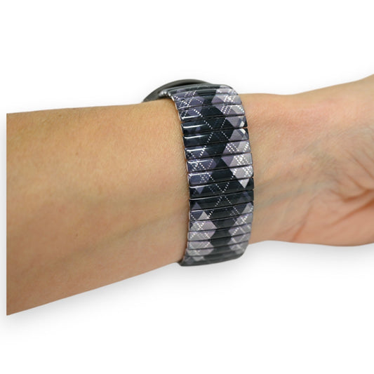 Elastisches Armband mit schwarz-grauem Paisleymuster auf Handgelenk, modernes Design für Armbanduhren