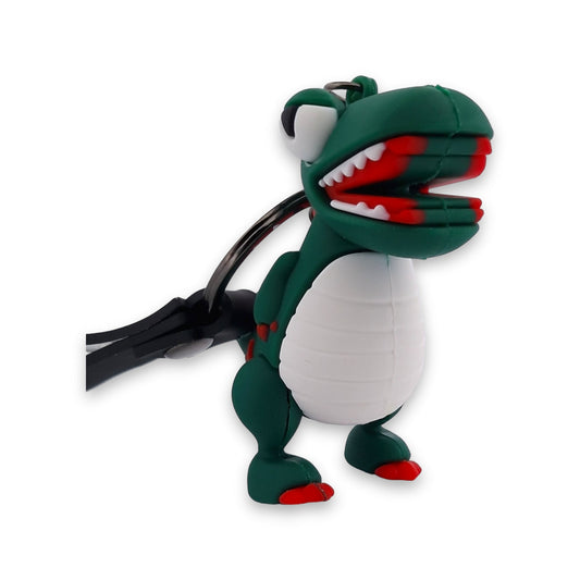 Niedlicher 3D-Dinosaurier-Schlüsselanhänger in Grün und Weiß mit offenem Maul und roten Details, auf weißem Hintergrund