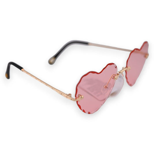 Modische Sonnenbrille mit herzförmigen rosa Gläsern und goldenem Metallgestell, ideal für sommerliche Looks