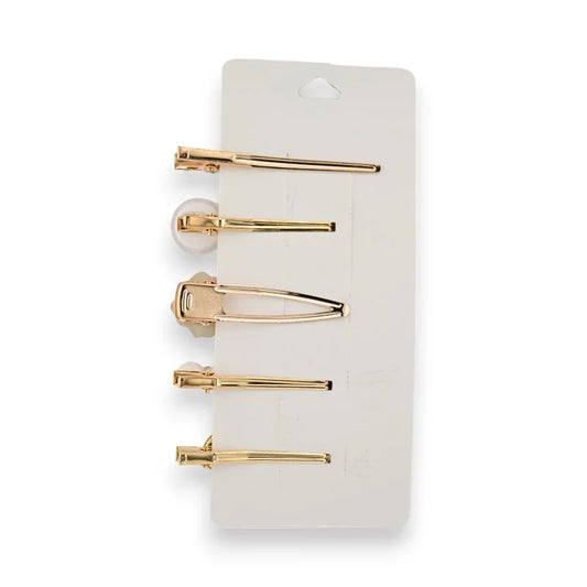Set aus 5 eleganten goldenen Haarspangen auf einem weißen Präsentationsständer