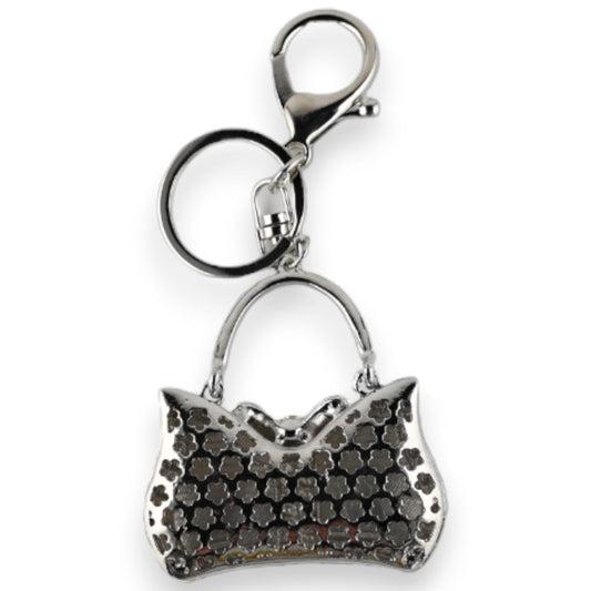 Silberner Schlüsselanhänger mit Anhänger in Form einer Handtasche, verziert mit schwarz-weißem Blumenmuster