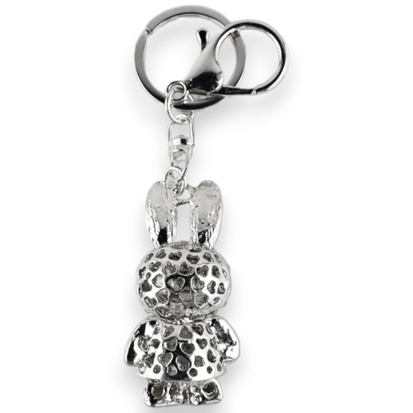Silberner Schlüsselanhänger mit Hasenfigur, texturierter Oberfläche und grauem Rock. Dekoratives Accessoire mit Herzmuster.