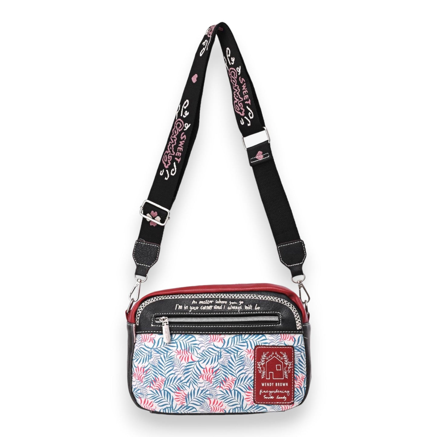 Stilvolle Umhängetasche mit tropischem Muster, schwarzem Riemen und rotem Akzent. Wendy Brown Design mit inspirierendem Zi...