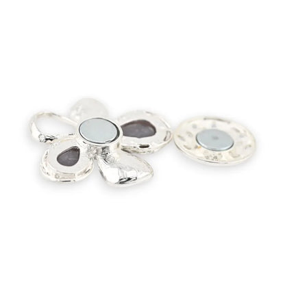 Silberne Blumenbrosche mit Metallblütenblättern und schwarzen und grauen Cabochons, Verschluss ai...