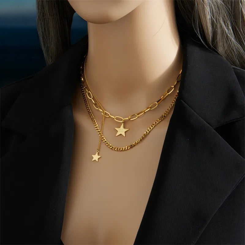 Goldene Doppelkette mit Sternenanhängern auf Schaufensterpuppe, elegant kombiniert mit schwarzem Blazer