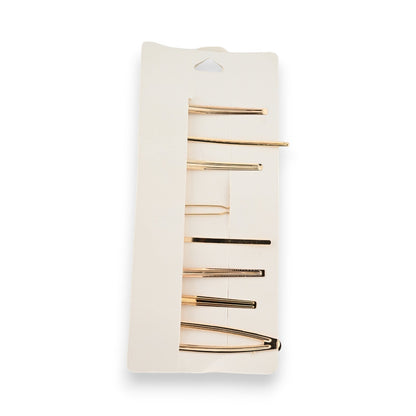Set mit 8 goldenen Haarspangen auf weißer Karte, minimalistisches Design, verschiedene Längen und Formen für moderne Frisuren