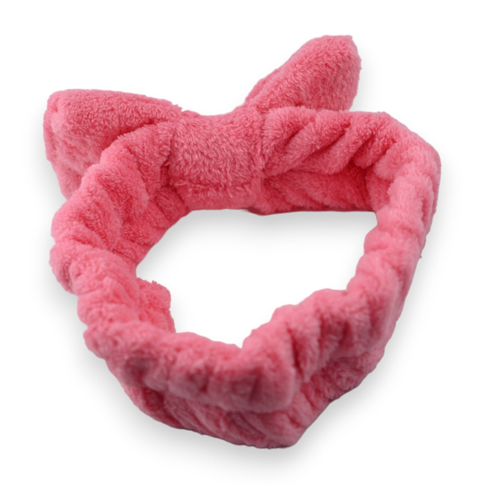 Flauschige pinkfarbene Stirnbinde aus weichem Plüschmaterial für Make-up und Gesichtspflege, auf weißem Hintergrund