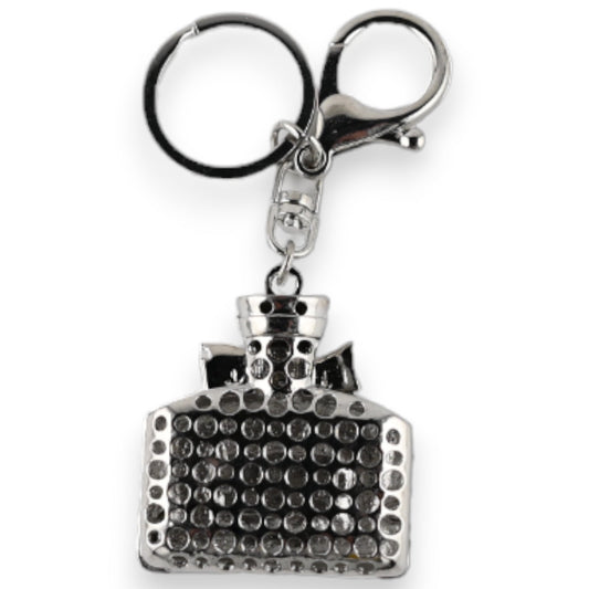 Silberner Schlüsselanhänger in Form einer eleganten Parfümflasche mit glitzernden Kristallen besetzt, Modeschmuck