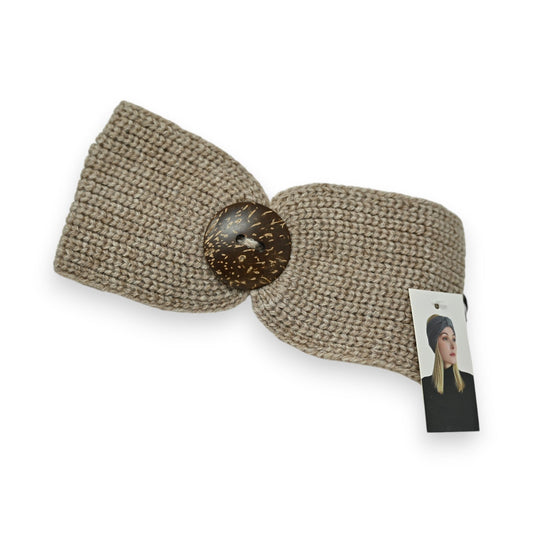 Taupe Strick-Stirnband mit großem Holzknopf, gestrickt aus dicker Wolle. Produktetikett mit Modellfoto angehängt.