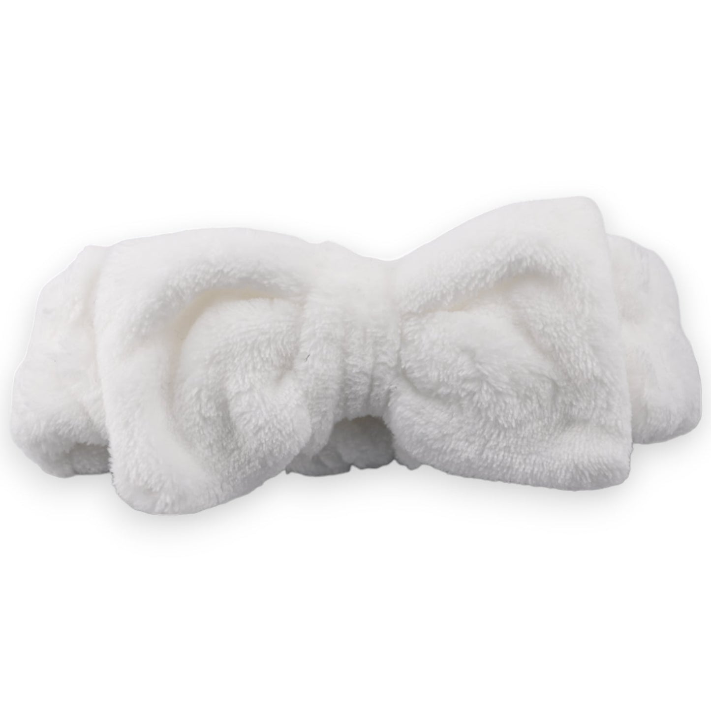 Weiches, flauschiges Make-up-Stirnband in Weiß, gefaltet und kuschelig, für Gesichtsreinigung und Kosmetikanwendungen